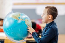 schoolboy-searching-places-globe-geography-class_232070-17146.jpg